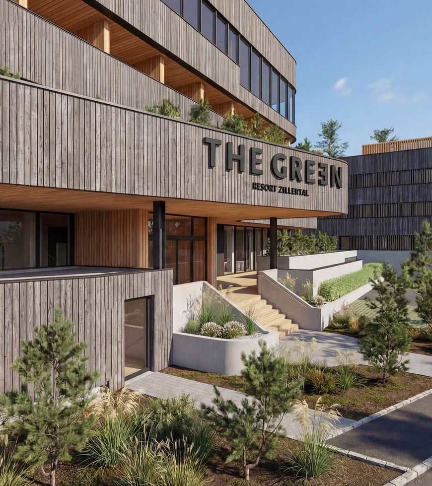 Eingangsbereich eines modernen Gebäudes mit Holzfassade und dem Schriftzug 'THE GREEN'