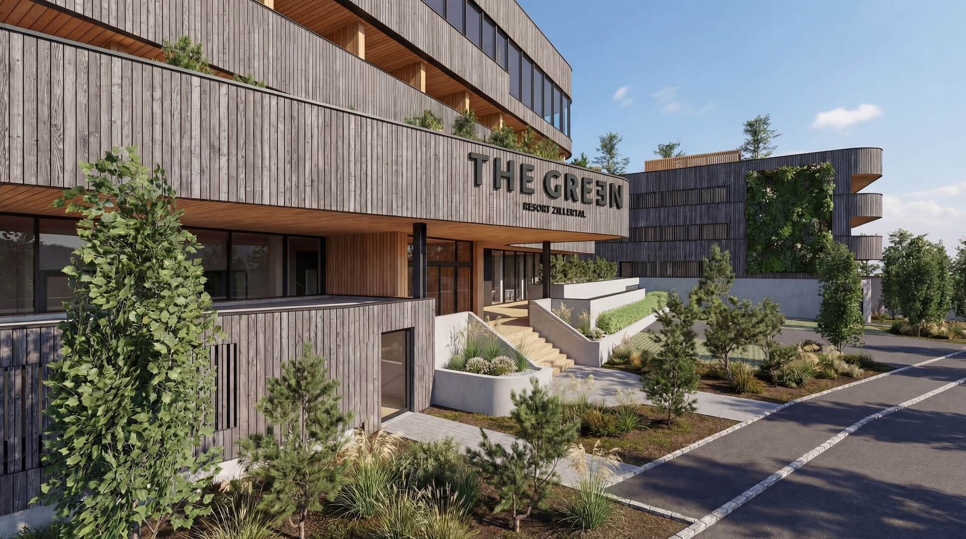 Eingangsbereich eines modernen Gebäudes mit Holzfassade und dem Schriftzug 'THE GREEN'