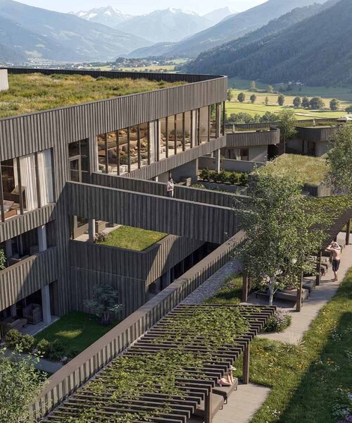 Modernes Gebäude mit begrüntem Flachdach und Pool in einer Berglandschaft