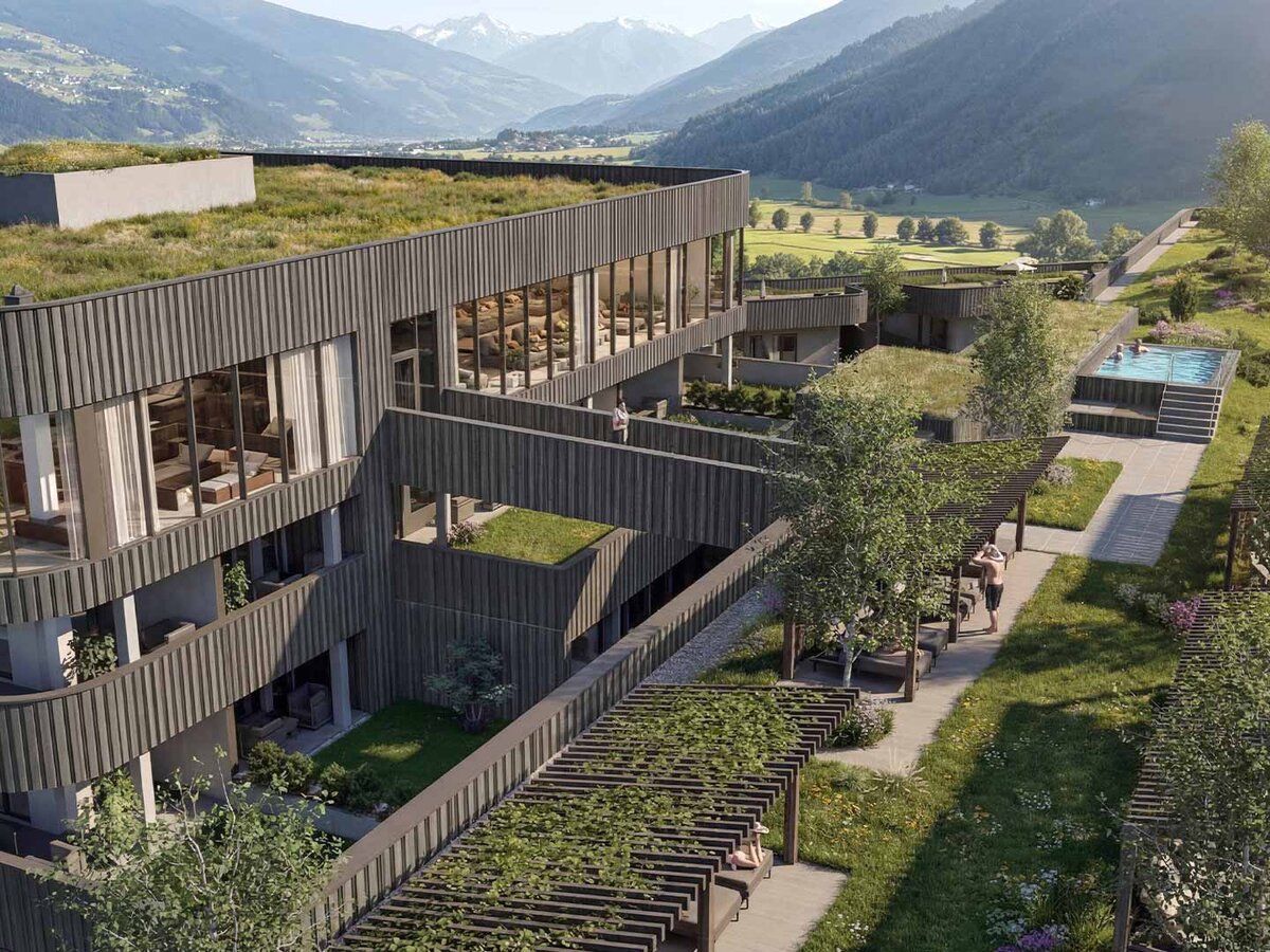 Modernes Gebäude mit begrüntem Flachdach und Pool in einer Berglandschaft