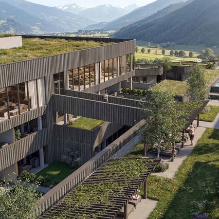 Modernes Gebäude mit begrüntem Flachdach und Pool in einer Berglandschaft