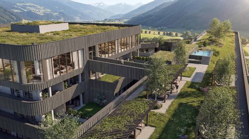 Modernes Gebäude mit begrüntem Flachdach und Pool in einer Berglandschaft