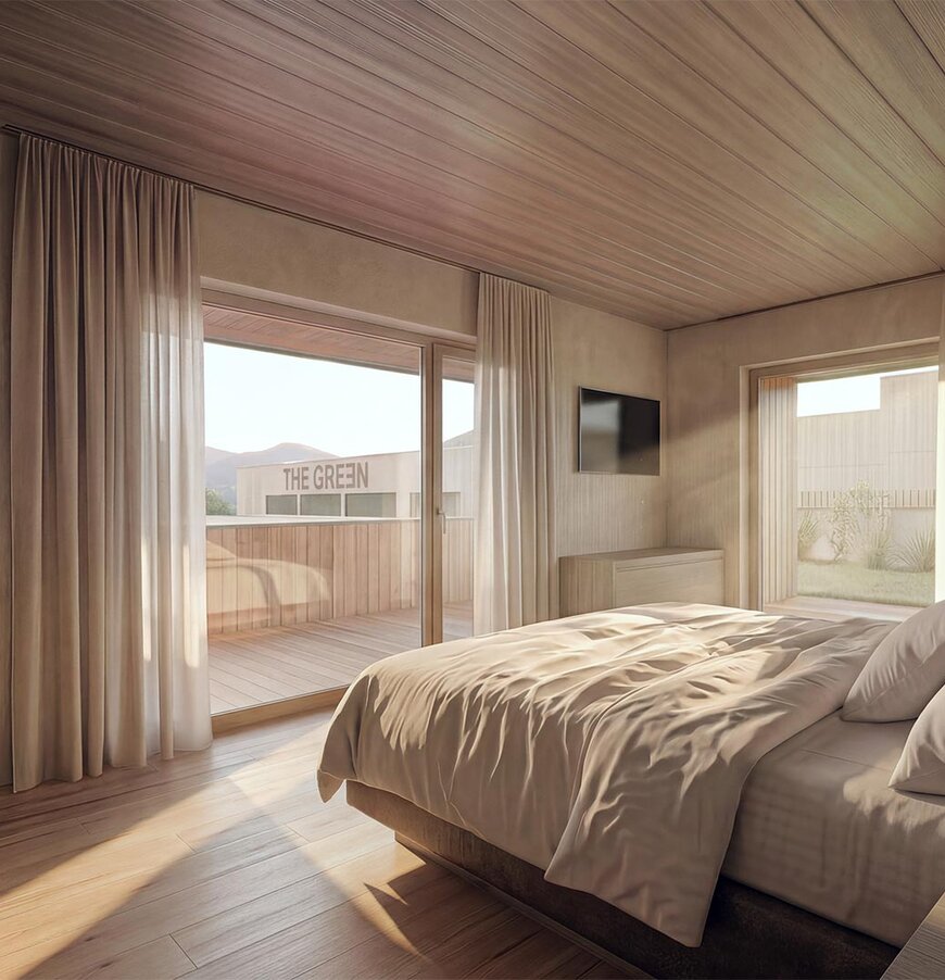 Schlafzimmer mit großem Bett, Holzwänden und -boden, Zugang zu Balkon mit Sitzmöbeln